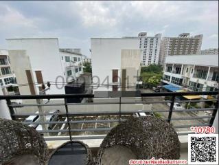 View from balcony overlooking neighboring buildings and skyline