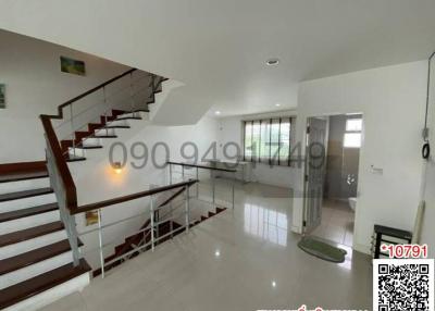 Spacious interior view of a modern building with staircase and ample natural lighting