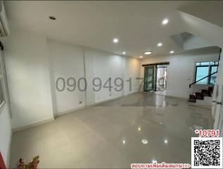 Spacious and well-lit empty interior of a residential building with shiny tiled flooring