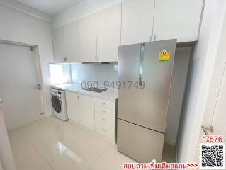 Modern kitchen with white cabinets and stainless steel appliances