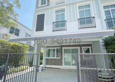 Exterior front view of a modern two-story house with gated entrance