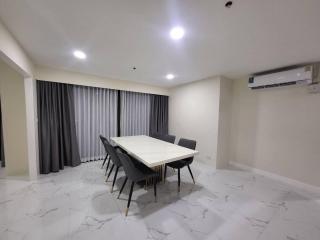 Spacious dining room with modern table set and elegant marble flooring