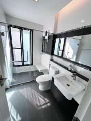 Modern bathroom interior with shower and white fittings