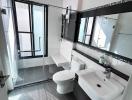 Modern bathroom interior with shower and white fittings