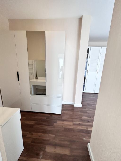 Bright hallway with wooden flooring leading to rooms