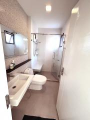 Modern bathroom with walk-in shower and white fixtures