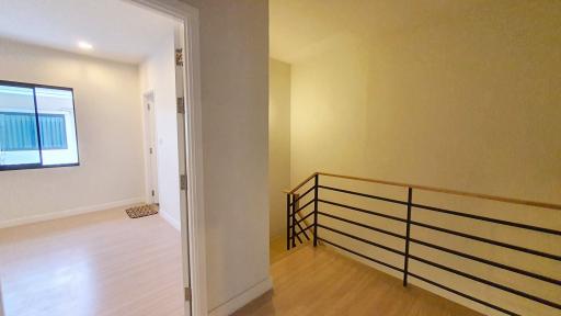 Spacious hallway leading to rooms with natural light