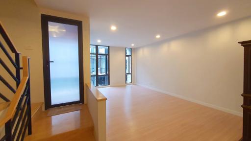 Spacious living room with hardwood floors and large windows