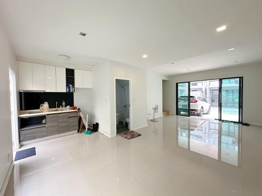 Spacious modern kitchen with glossy floor and large windows