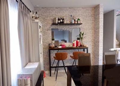 Modern kitchen with bar seating and exposed brick wall