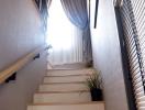 Bright staircase with window and wooden banister