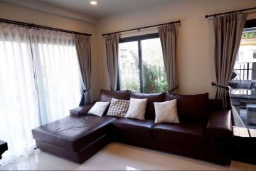 Contemporary living room with large L-shaped sofa and garden view