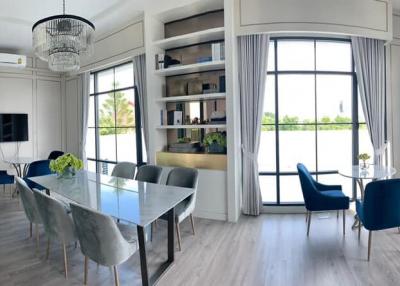 Modern living room with dining area, natural light, and stylish decor