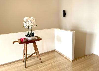 Minimalistic living area with wooden flooring and decorative side table