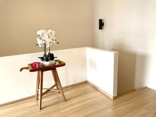 Minimalistic living area with wooden flooring and decorative side table