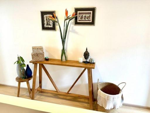 Elegant wooden console table with decorative items in a modern living area