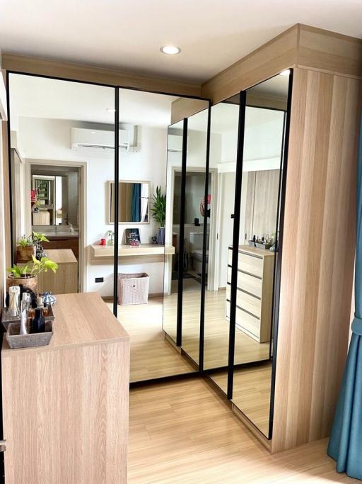 Modern apartment interior with kitchen view through a reflective glass partition