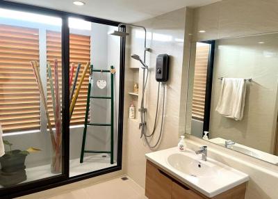 Modern bathroom with glass shower and wooden accents