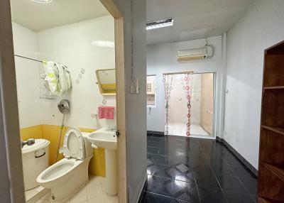 Compact bathroom with shower and simple fixtures