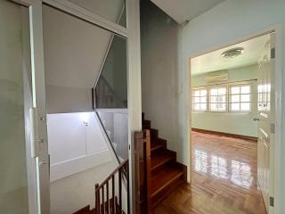 Interior staircase with wooden banister and hardwood flooring