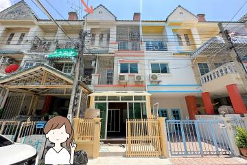 Three-story residential building with individual balconies and gated entrance