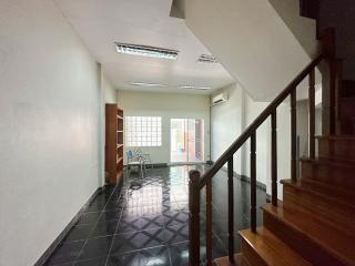 Spacious living room with staircase and ample natural light