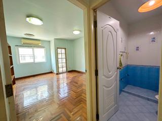 Entryway leading to a living room with a view into the kitchen