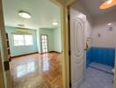 Entryway leading to a living room with a view into the kitchen