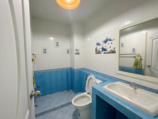Spacious bathroom with blue tiles and modern fixtures