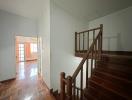 Wooden staircase leading to the upper level in a well-lit home