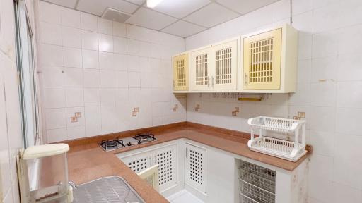 Spacious kitchen with tile backsplash and ample cabinetry