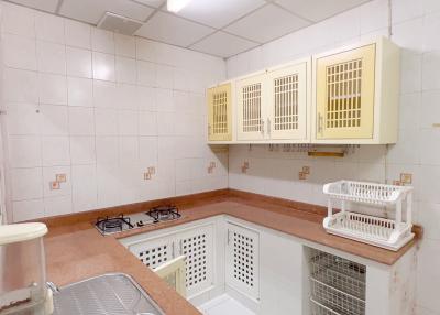 Spacious kitchen with tile backsplash and ample cabinetry