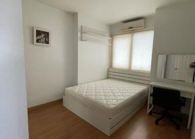 compact bedroom with natural light and hardwood floor