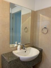 Modern bathroom with granite countertop and ceramic sink