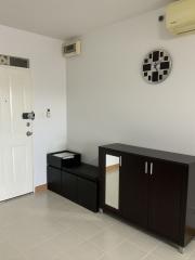 Clean and modern entryway with white walls and tiled flooring