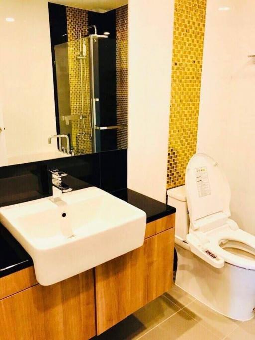 Modern bathroom with wood cabinetry and yellow accented tiles