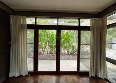 Spacious living room with large windows and garden view