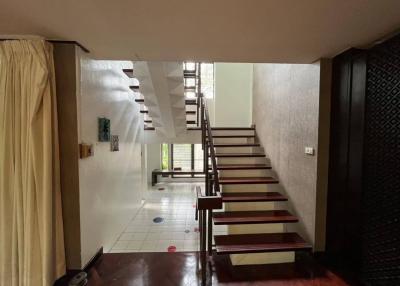 Hallway with staircase and tiled floor