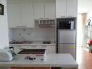 Modern kitchen with stainless steel appliances and white cabinetry