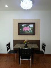 Contemporary dining room with a wooden table, modern chairs, and an artistic light fixture