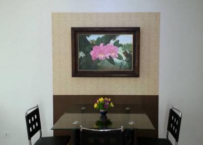 Contemporary dining room with a wooden table, modern chairs, and an artistic light fixture