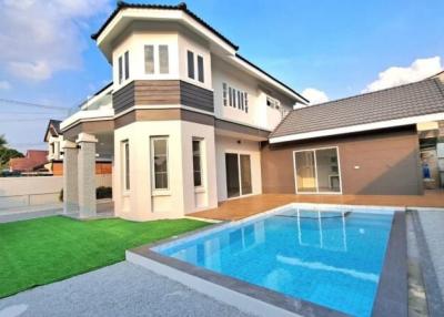 Spacious two-story house with a swimming pool and artificial lawn