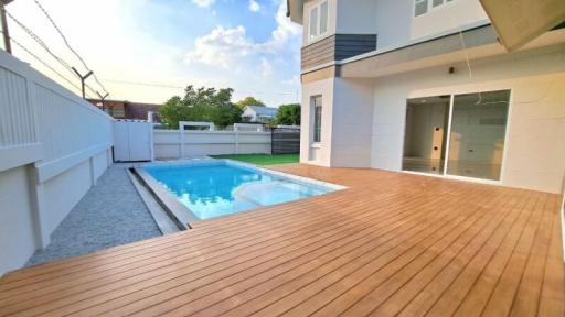 Modern house exterior with swimming pool and wooden deck