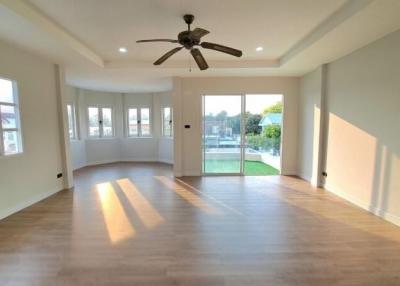 Spacious living room with ample natural light and modern flooring