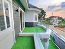 Modern home exterior with terrace and artificial grass