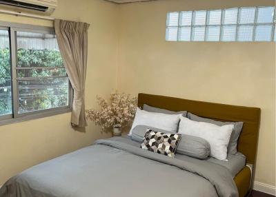 Cozy bedroom with queen-sized bed and decorative ceiling