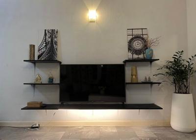 Modern living room with wall-mounted shelves and decorative items