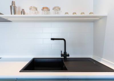 Modern kitchen with white subway tile backsplash and black countertop