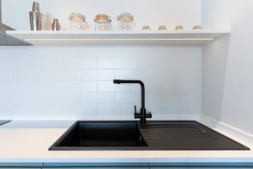 Modern kitchen with white subway tile backsplash and black countertop