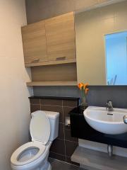 Modern bathroom with wooden cabinets and a compact layout